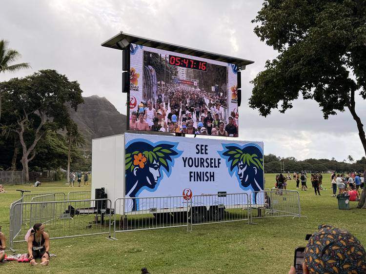 TV1 mobile LED trailer showing the Honolulu Marathon finish-line feed beneath Diamond Head